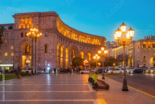 Capital of Armenia. Evening Yerevan. Beautiful building with evening lighting. Lanterns and scooters on streets of Armenia. Architecture of Yerevan. Holidays in Armenia. Holidays in Yerevan