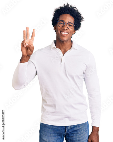 Handsome african american man with afro hair wearing casual clothes and glasses showing and pointing up with fingers number three while smiling confident and happy.