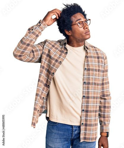 Handsome african american man with afro hair wearing casual clothes and glasses confuse and wondering about question. uncertain with doubt, thinking with hand on head. pensive concept.
