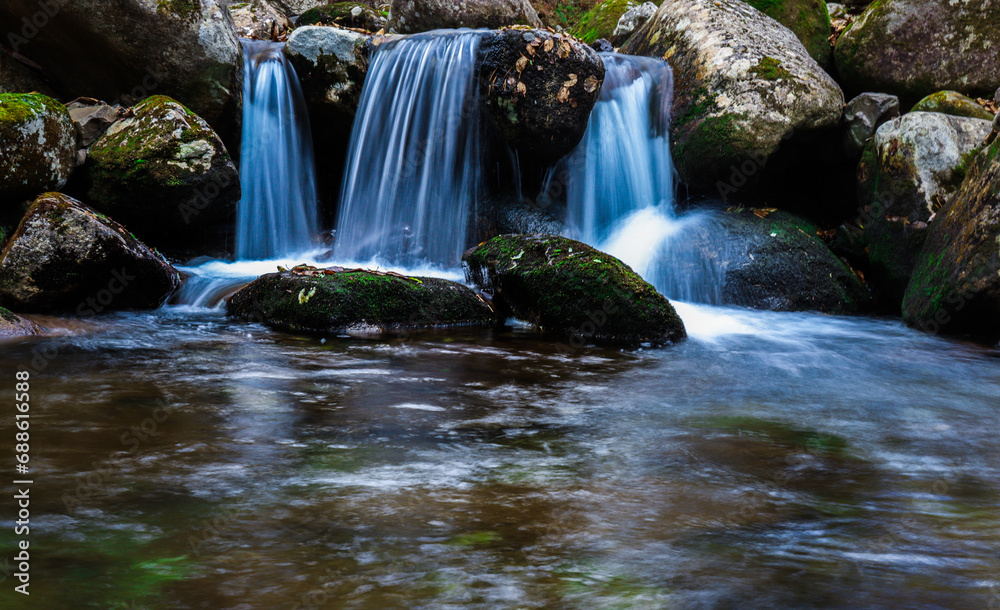 Fototapeta premium Waterfall. Tourism and travel in autumn. Holidays in the mountains.