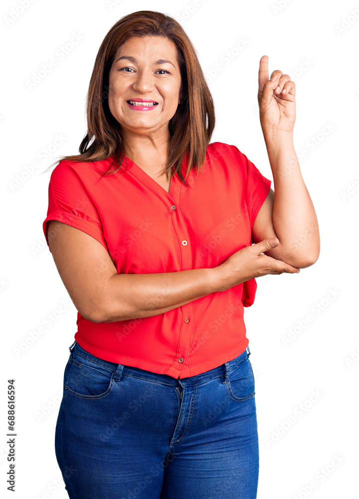 Middle age latin woman wearing casual clothes smiling happy pointing with hand and finger to the side Middle age latin woman wearing casual clothes smiling happy pointing with hand and finger to the side
