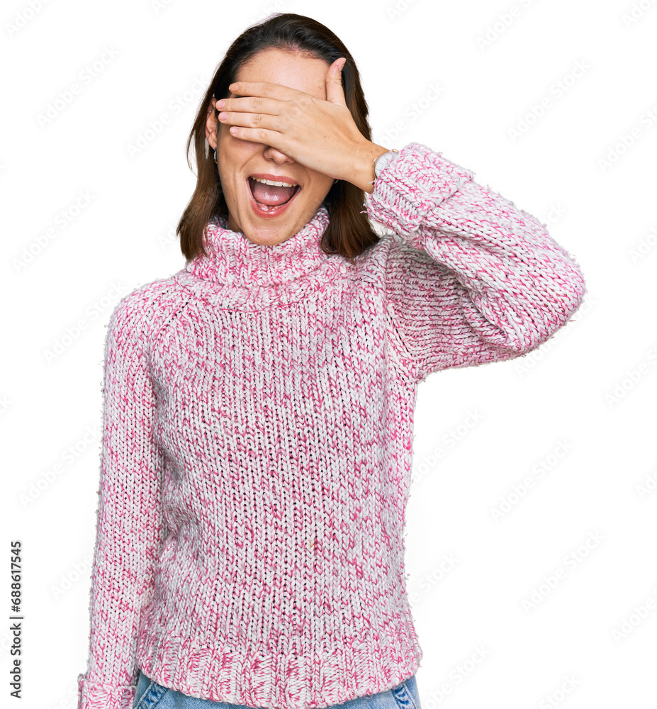 Young caucasian girl wearing wool winter sweater smiling and laughing with hand on face covering eyes for surprise. blind concept. Young caucasian girl wearing wool winter sweater smiling and laughing with hand on face covering eyes for surprise. blind concept.