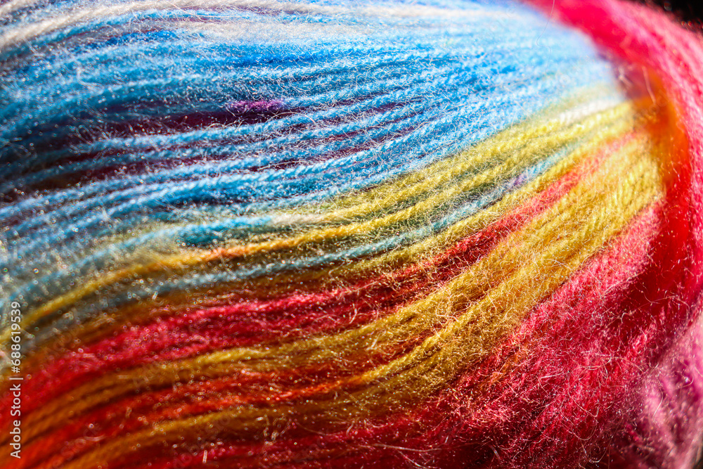 Selective focus. Multi-colored threads for knitting. Rainbow texture.