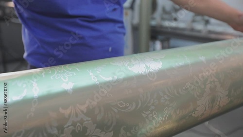 Rolling shaft in closeup. New modern equipment. Modern wallpaper production. Close up of big Rolls of wallpaper production. Printing roller for wallpaper production photo