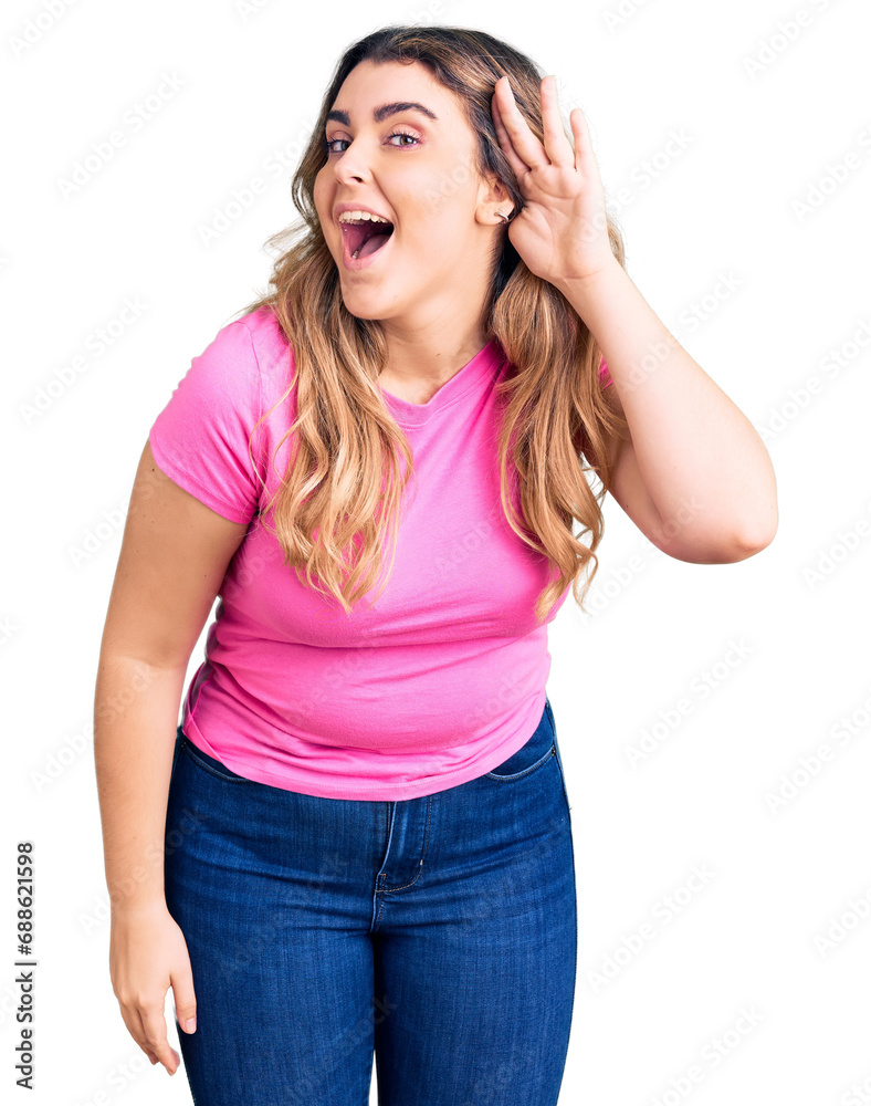 Young caucasian woman wearing sportswear smiling with hand over ear listening an hearing to rumor or gossip. deafness concept. Young caucasian woman wearing sportswear smiling with hand over ear listening an hearing to rumor or gossip. deafness concept.
