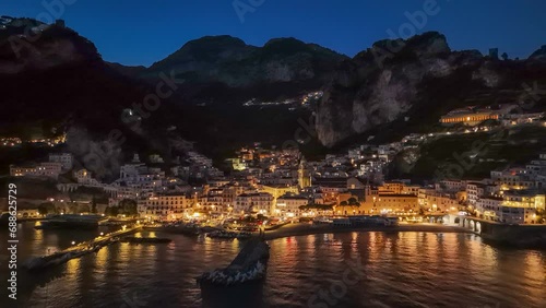 Aerial evening shot of Amalfi town with city lights. Famous Amalfi coast in Campagna, Italy. 4K, UHD photo