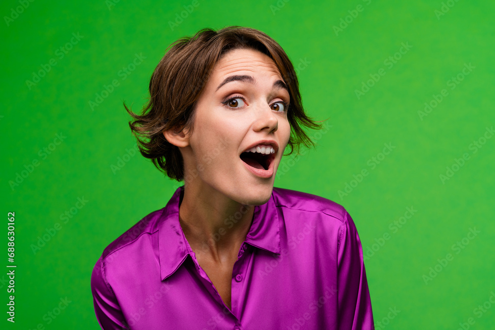 Portrait of astonished cheerful person open mouth cant believe news isolated on green color background - obrazy, fototapety, plakaty 