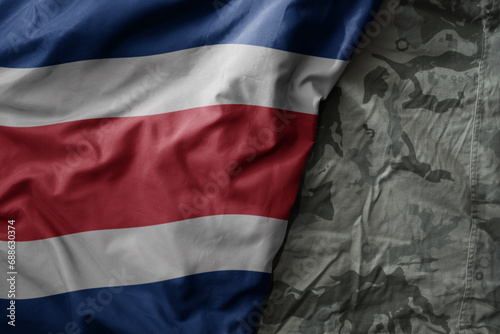 waving flag of on the old khaki texture background. military concept.
