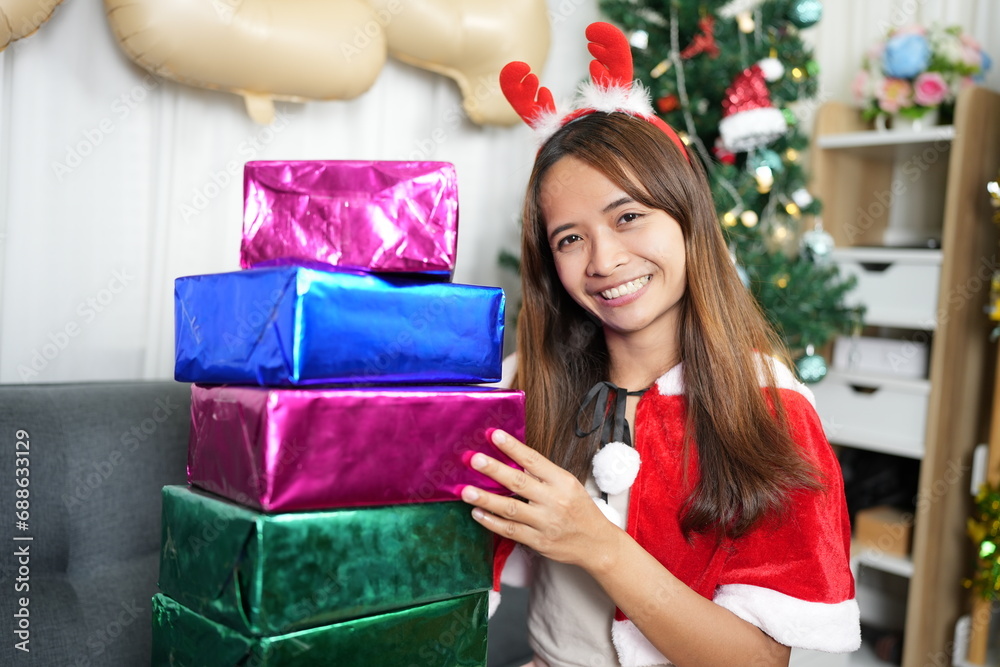 Merry Christmas 2024 concept Asian women are happy and delighted to receive Christmas gifts. Merry Christmas 2024 concept Asian women are happy and delighted to receive Christmas gifts.