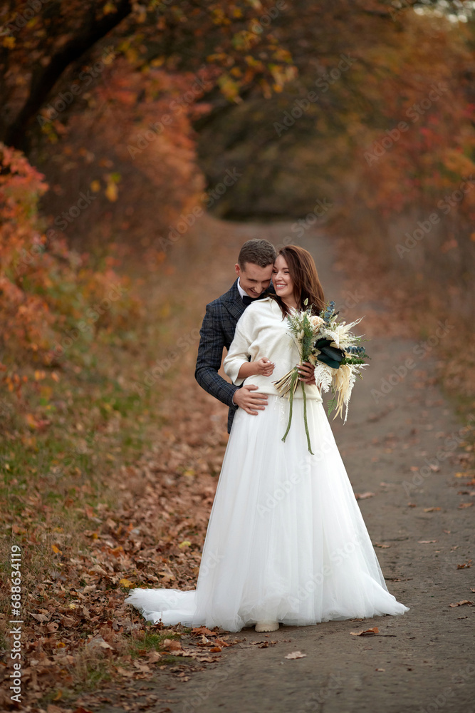 beautiful sensual bride in white wedding dress and groom standing outdoor