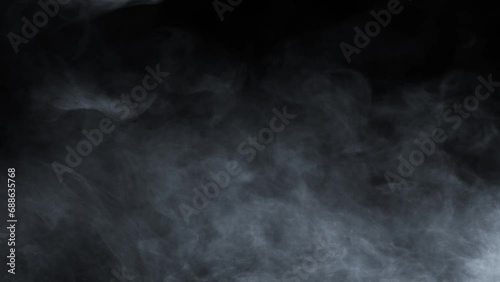 Atmospheric smoke 4K Fog effect. VFX Element. Haze background. Abstract smoke cloud. Smoke in slow motion on black background. White smoke slowly floating through space against black photo