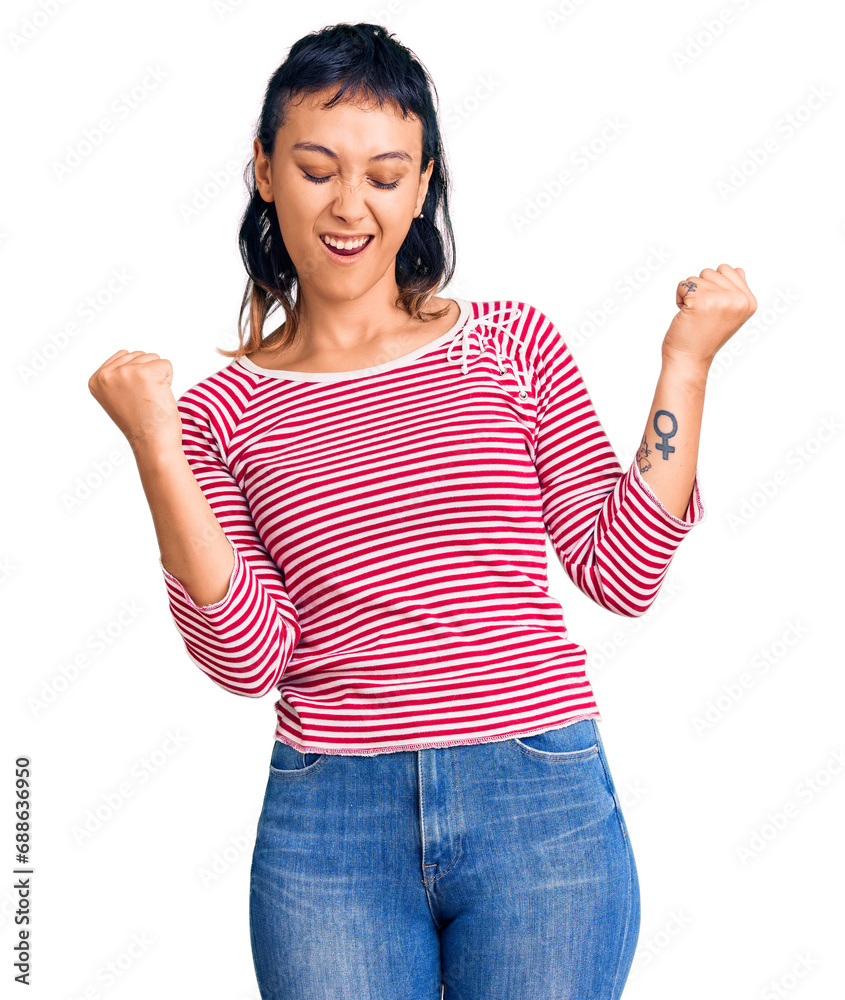 Young woman wearing casual clothes very happy and excited doing winner gesture with arms raised, smiling and screaming for success. celebration concept. Young woman wearing casual clothes very happy and excited doing winner gesture with arms raised, smiling and screaming for success. celebration concept.