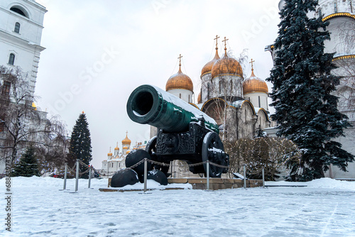 Inside the Kremlin's wall - Tsar pushka with Ivan the Great Bell Tower, Ivan the Great Bell and the Dormition Cathedral background in Cathedral Square Moscow Russia.