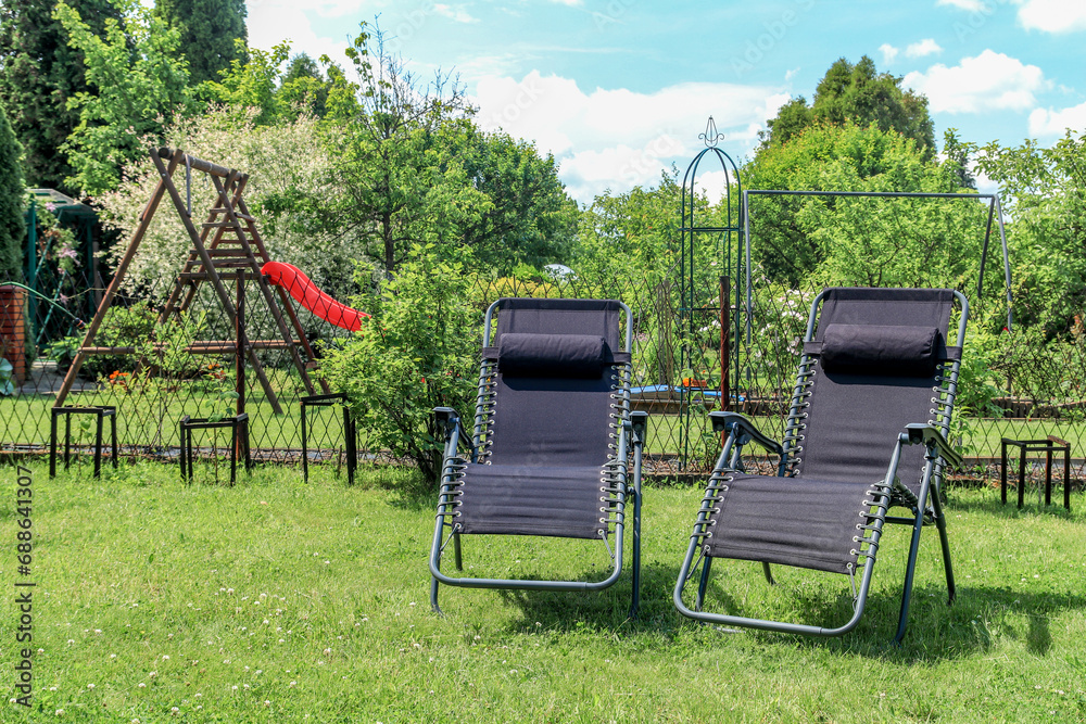 Folding deckchairs on the garden lawn Folding deckchairs on the garden lawn