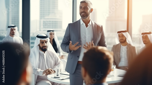 A Dubai businessman gives a clever presentation to a business partner photo