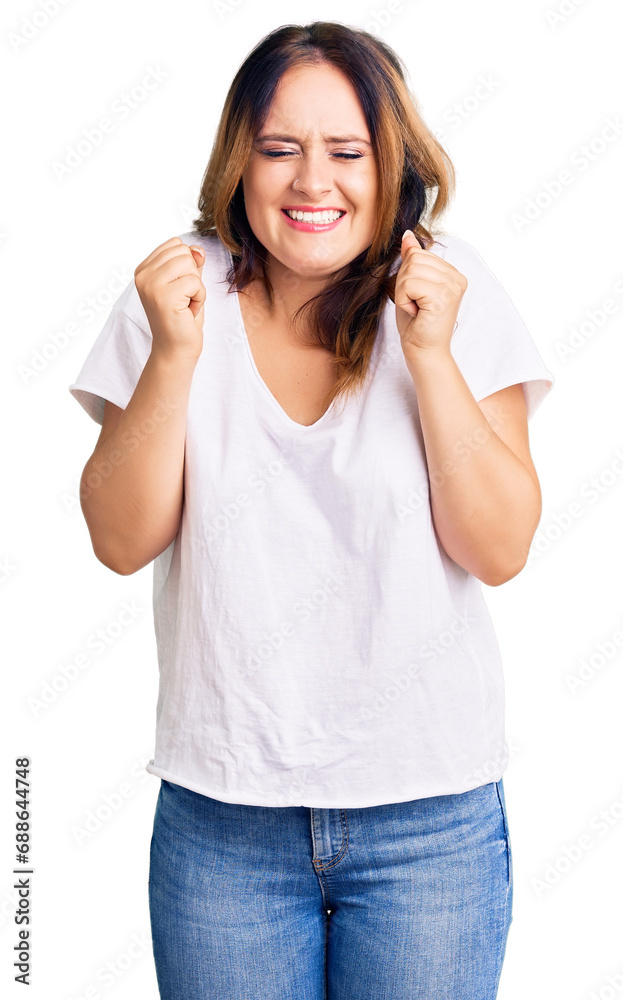 Young beautiful caucasian woman wearing casual white tshirt excited for success with arms raised and eyes closed celebrating victory smiling. winner concept. Young beautiful caucasian woman wearing casual white tshirt excited for success with arms raised and eyes closed celebrating victory smiling. winner concept.