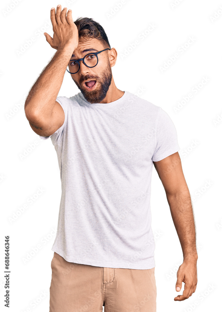 Young hispanic man wearing casual clothes and glasses surprised with hand on head for mistake, remember error. forgot, bad memory concept. Young hispanic man wearing casual clothes and glasses surprised with hand on head for mistake, remember error. forgot, bad memory concept.