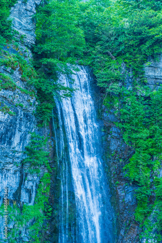 Maral Waterfall and the mountains and green vegetation around it located within the borders of Artvin province