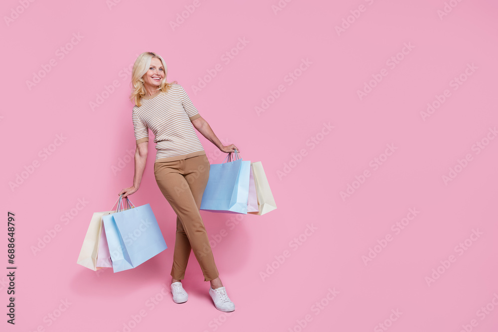 Full length photo of lovely cute lady dressed fashionable outfit standing empty space isolated on pink color background Full length photo of lovely cute lady dressed fashionable outfit standing empty space isolated on pink color background