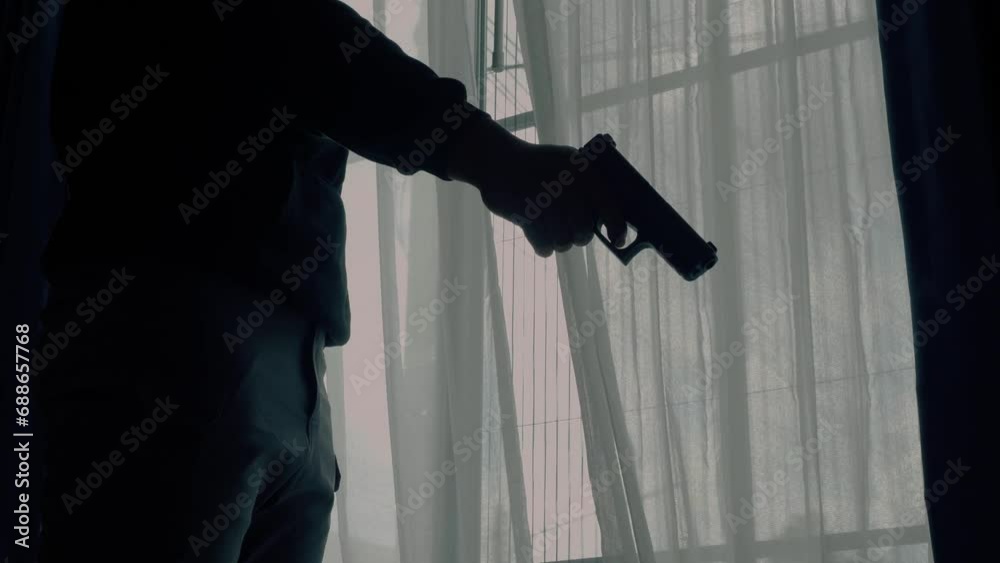 Mysterious Man Wearing Black Hoodie Holding A Pistol Wearing A Cloth