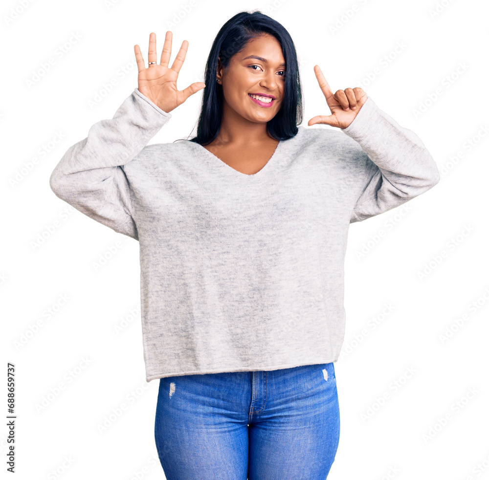 Hispanic woman with long hair wearing casual clothes showing and pointing up with fingers number seven while smiling confident and happy. Hispanic woman with long hair wearing casual clothes showing and pointing up with fingers number seven while smiling confident and happy.