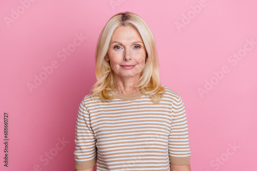 Photo of good mood senior nice person with blond hairstyle dressed striped t-shirt look at camera isolated on pink color background