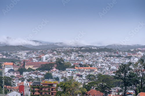 View on roofs in the city of Dalat. Da Lat and the surrounding area is a popular tourist destination of Asia. City with fogs and mountains