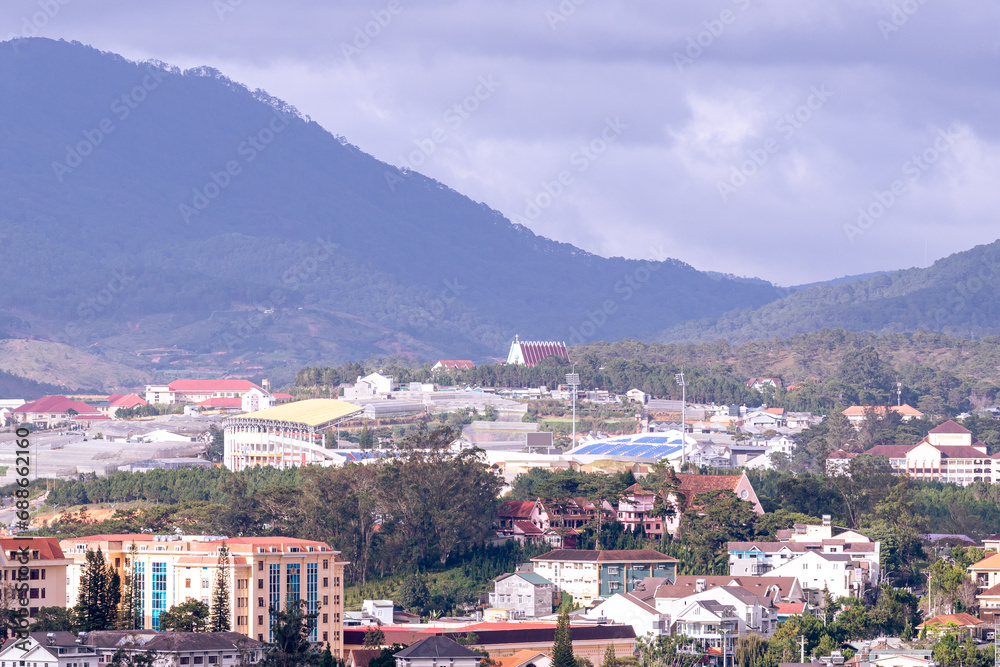 View on roofs in the city of Dalat. Da Lat and the surrounding area is a popular tourist destination of Asia. City with fogs and mountains