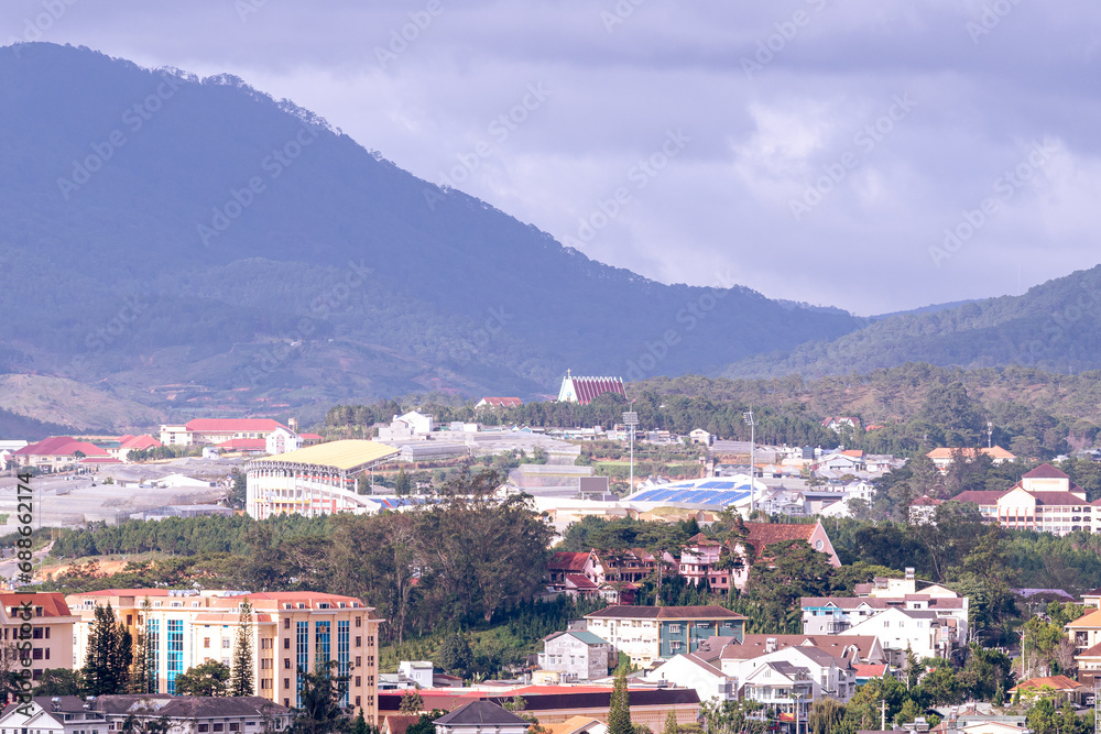 View on roofs in the city of Dalat. Da Lat and the surrounding area is a popular tourist destination of Asia. City with fogs and mountains