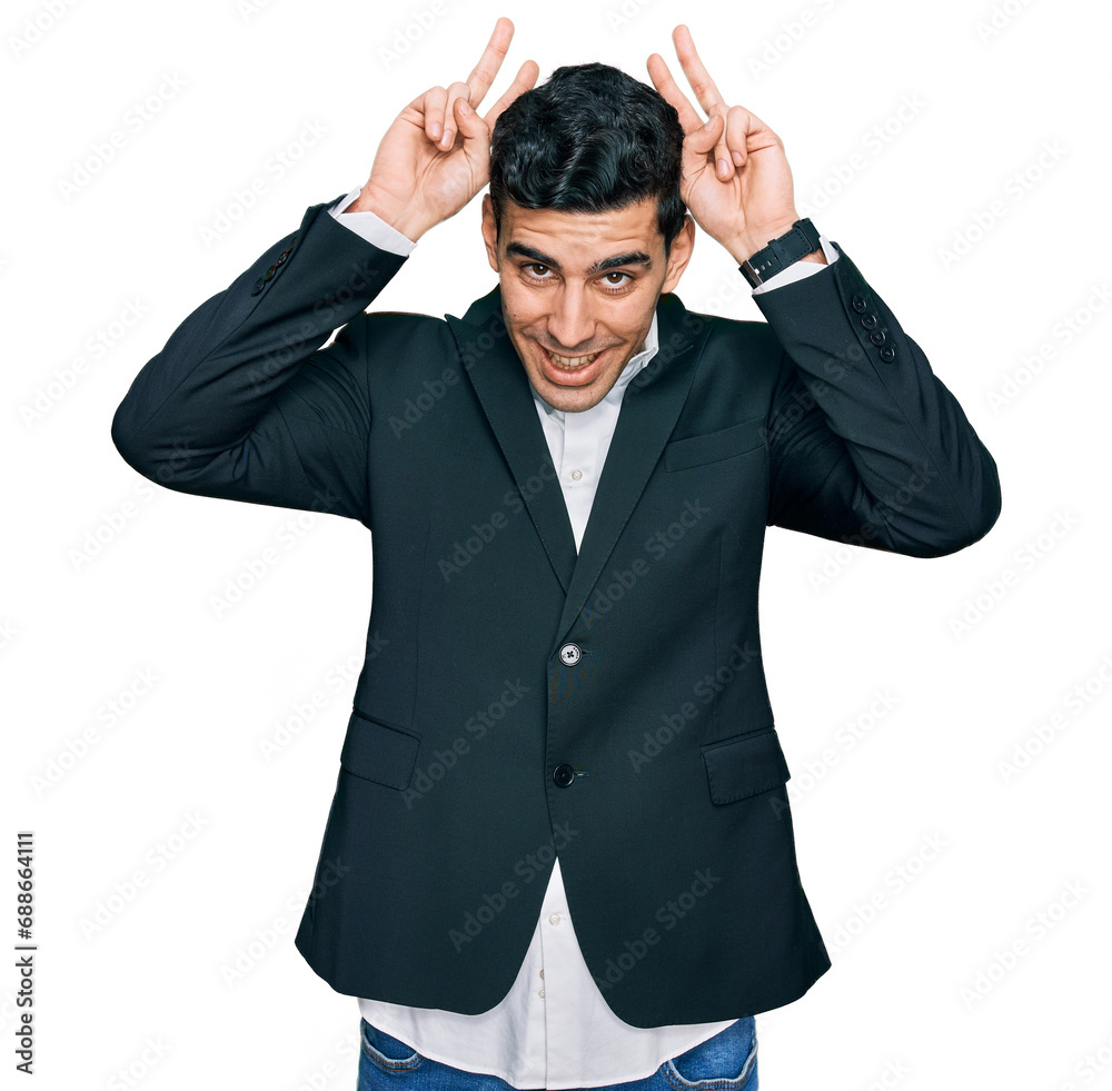 Handsome hispanic man wearing business clothes posing funny and crazy with fingers on head as bunny ears, smiling cheerful Handsome hispanic man wearing business clothes posing funny and crazy with fingers on head as bunny ears, smiling cheerful