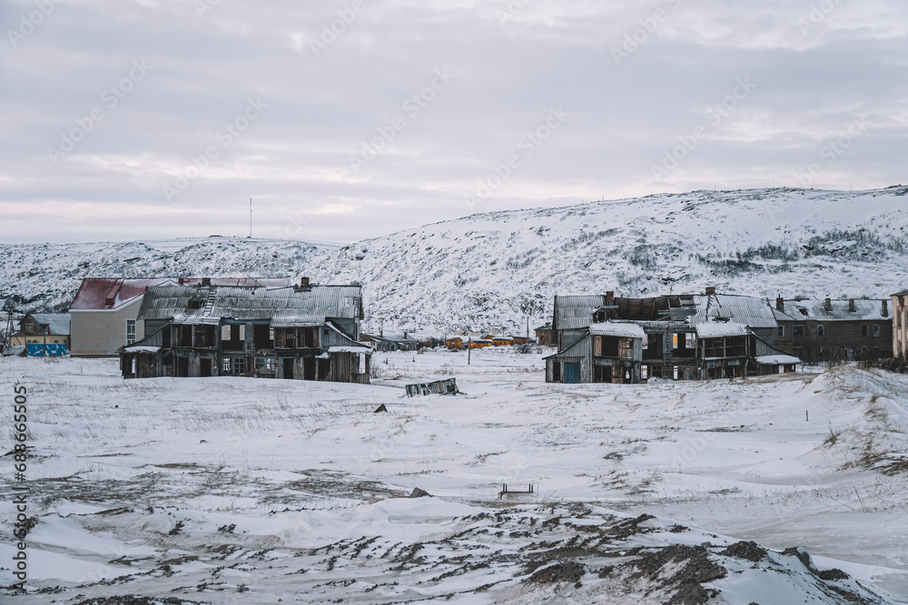 Teriberka is a village on the shore of the Arctic Ocean. The edge of the world. The far north of Russia. old fishing village on the shore of the sea. old ruined houses in winter.