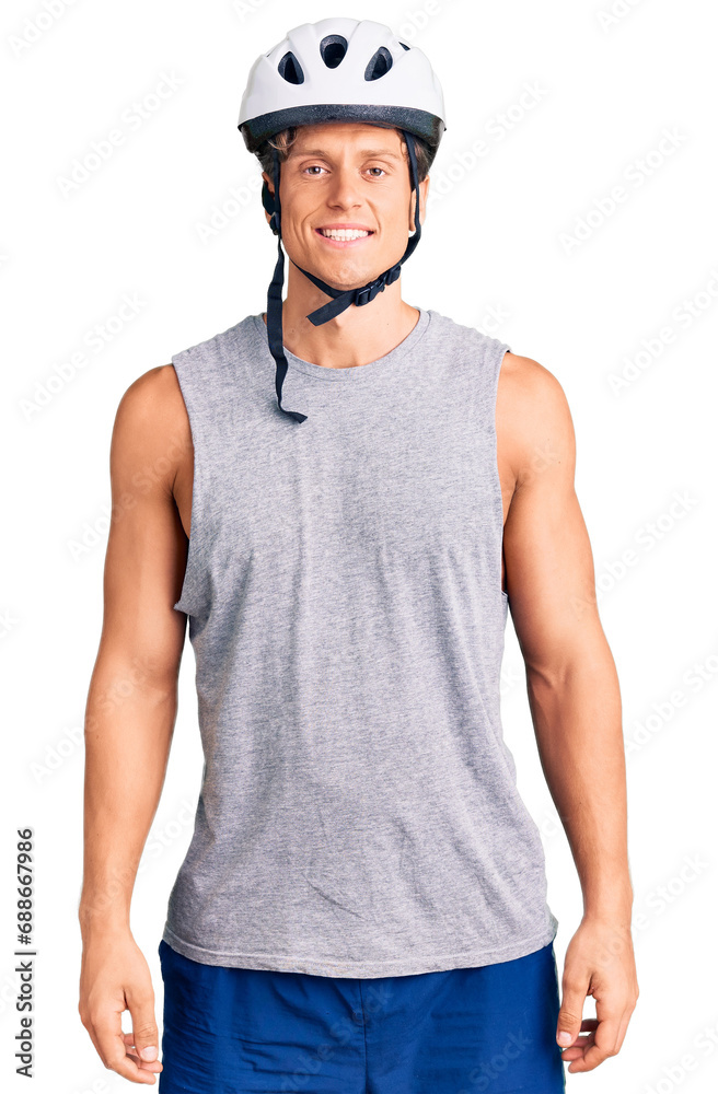 Young handsome man wearing bike helmet with a happy and cool smile on face. lucky person.