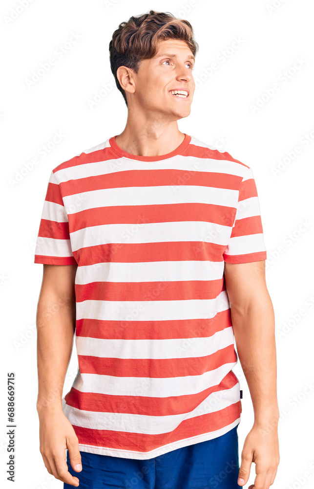 Young handsome man wearing casual clothes looking away to side with smile on face, natural expression. laughing confident. Young handsome man wearing casual clothes looking away to side with smile on face, natural expression. laughing confident.