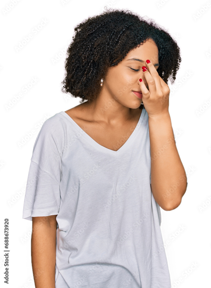 Young african american girl wearing casual clothes tired rubbing nose and eyes feeling fatigue and headache. stress and frustration concept. Young african american girl wearing casual clothes tired rubbing nose and eyes feeling fatigue and headache. stress and frustration concept.