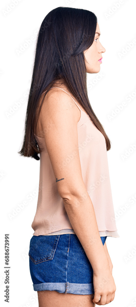 Young beautiful caucasian woman wearing casual clothes looking to side, relax profile pose with natural face with confident smile. Young beautiful caucasian woman wearing casual clothes looking to side, relax profile pose with natural face with confident smile.