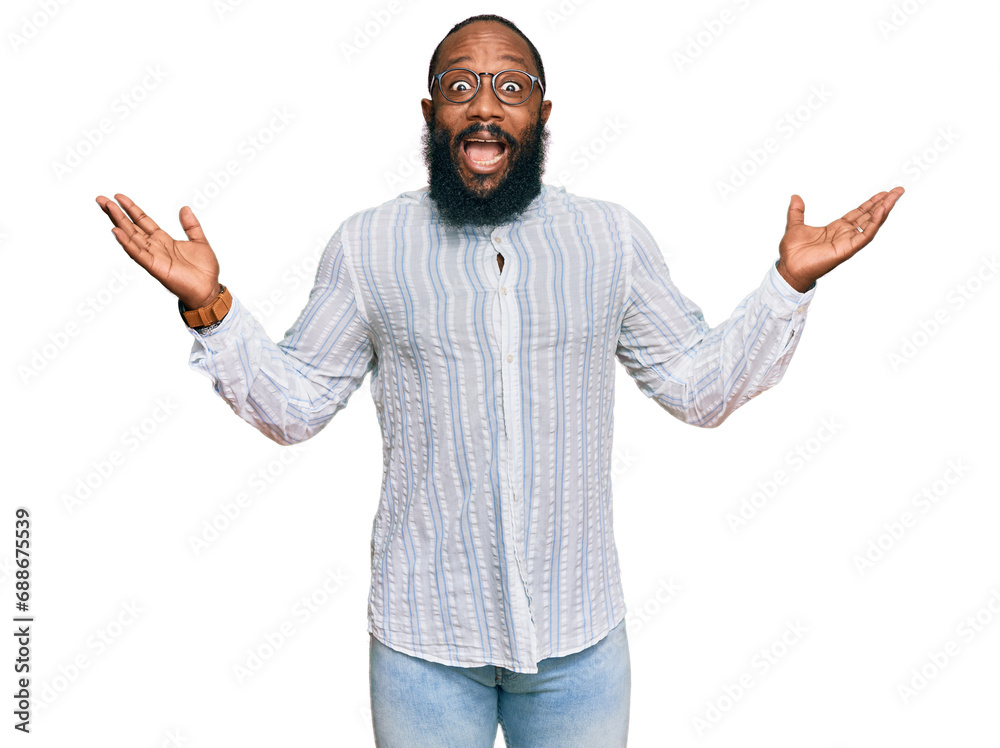 Young african american man wearing business shirt and glasses celebrating victory with happy smile and winner expression with raised hands