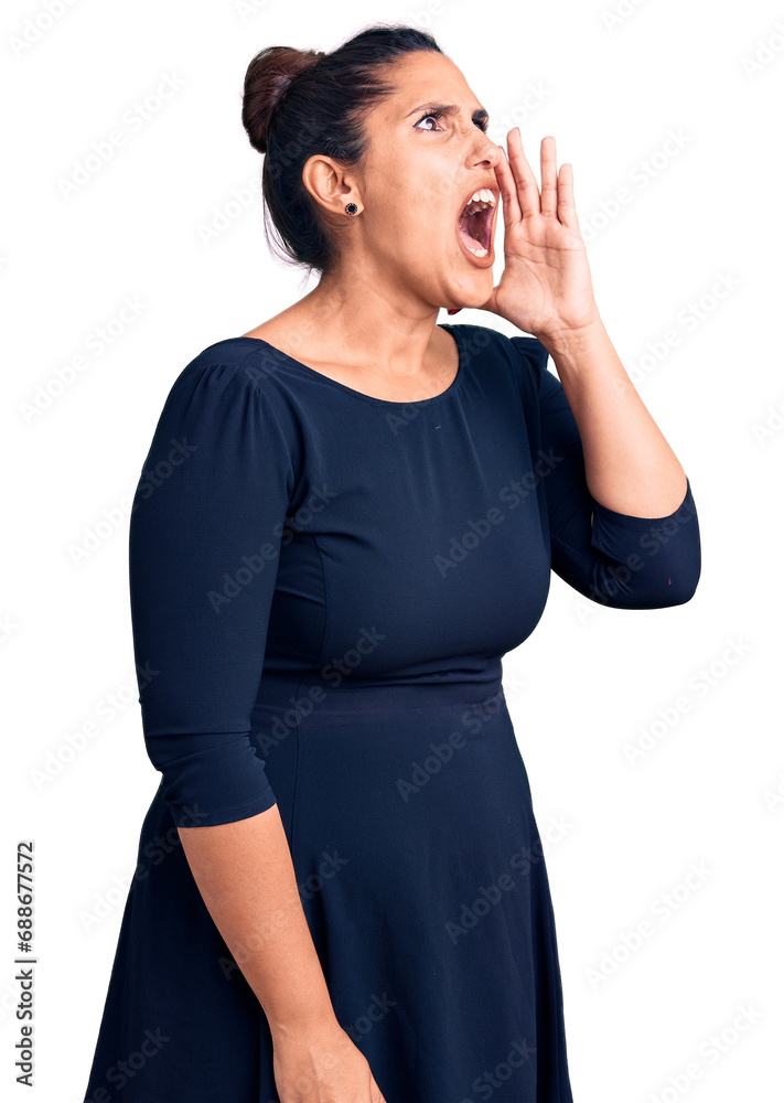 Young beautiful brunette woman wearing casual dress shouting and screaming loud to side with hand on mouth. communication concept. Young beautiful brunette woman wearing casual dress shouting and screaming loud to side with hand on mouth. communication concept.