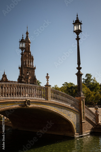 Pituresque bridge and lamppost at the National Geographic Institute in Plaza de España Seville city Spain. Central government offices in stunning rich wealthy architecture design
