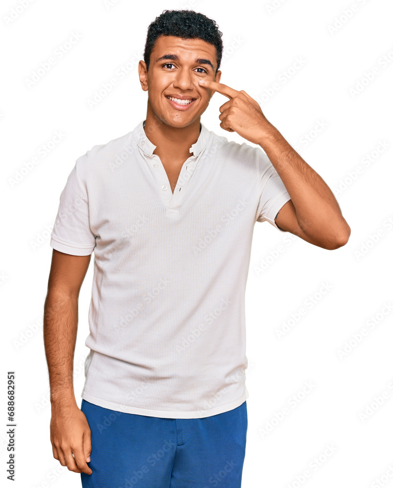 Young arab man wearing casual clothes pointing with hand finger to face and nose, smiling cheerful. beauty concept Young arab man wearing casual clothes pointing with hand finger to face and nose, smiling cheerful. beauty concept