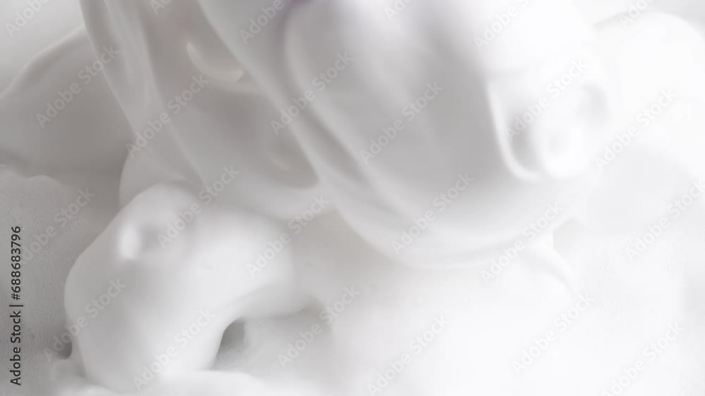 Soapsuds, close up. Hair foam mousse, macro. Beauty background. Close up of white cloud of hair mousse or shaving foam. Soapsuds, close up. Hair foam mousse, macro. Beauty background. Close up of white cloud of hair mousse or shaving foam.