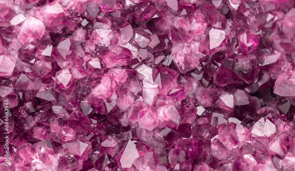 Amethyst pink crystals. Gems. Mineral crystals in the natural environment. Texture of precious and semiprecious stones. Seamless background with copy space colored shiny surface of precious stones.