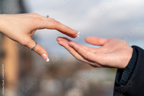 close-up of a man and a woman hand in hand. © Iryna