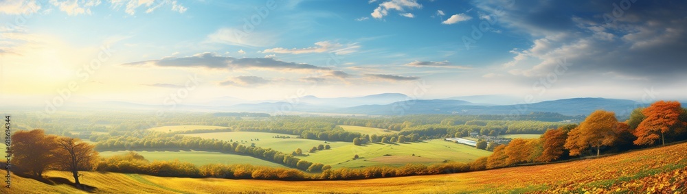 A pastoral countryside landscape during autumn, with colorful foliage framing a sky perfect for advertising text.