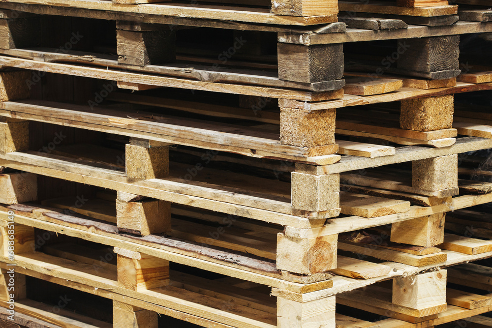 Stacked pallets background. Warehouse pallets texture. Storage unit. Pile of wooden transportation pallets. Import and export background. Shipment logistic. Shipping logistic pattern. Stacked pallets background. Warehouse pallets texture. Storage unit. Pile of wooden transportation pallets. Import and export background. Shipment logistic. Shipping logistic pattern.