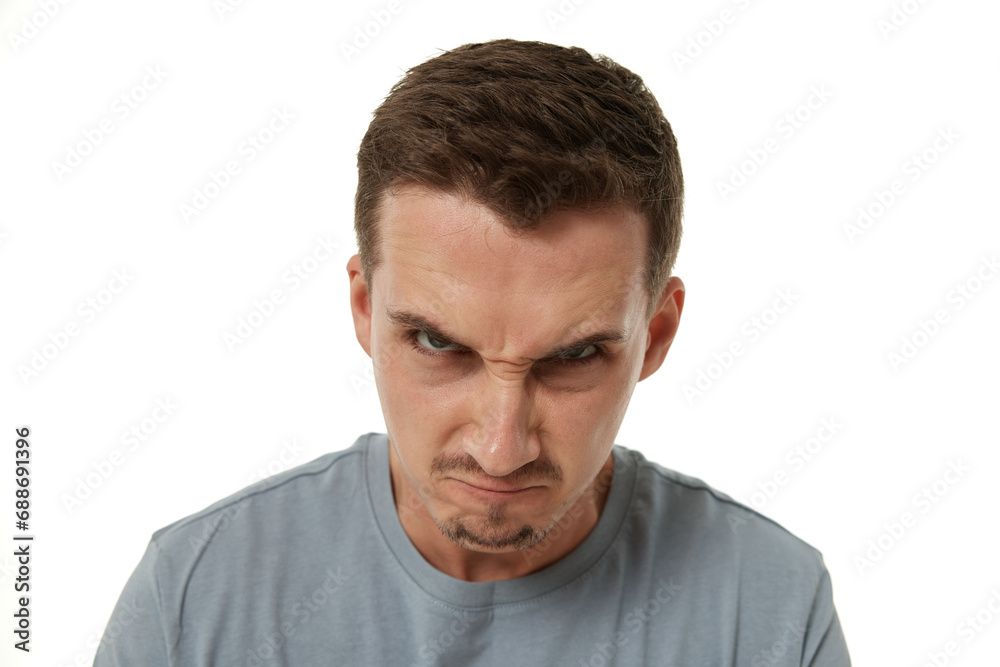 angry guy looking at camera on white studio background angry guy looking at camera on white studio background