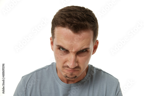 angry guy looking at camera on white studio background