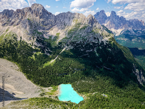 Aerial view of the blue turquoise Lake Sorapis (Lago di Sorapiss) with mountains with the background in Dolomites. One of the most beautiful lakes in Italy. Famous destination.