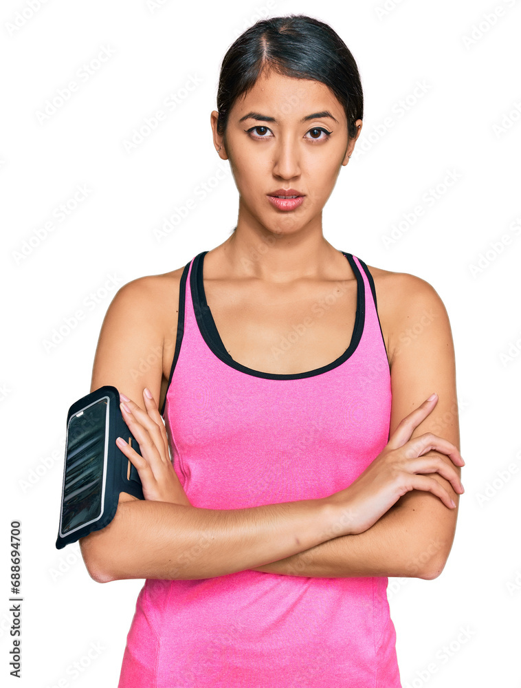 Beautiful asian young sport woman wearing sportswear and arm band skeptic and nervous, disapproving expression on face with crossed arms. negative person. Beautiful asian young sport woman wearing sportswear and arm band skeptic and nervous, disapproving expression on face with crossed arms. negative person.