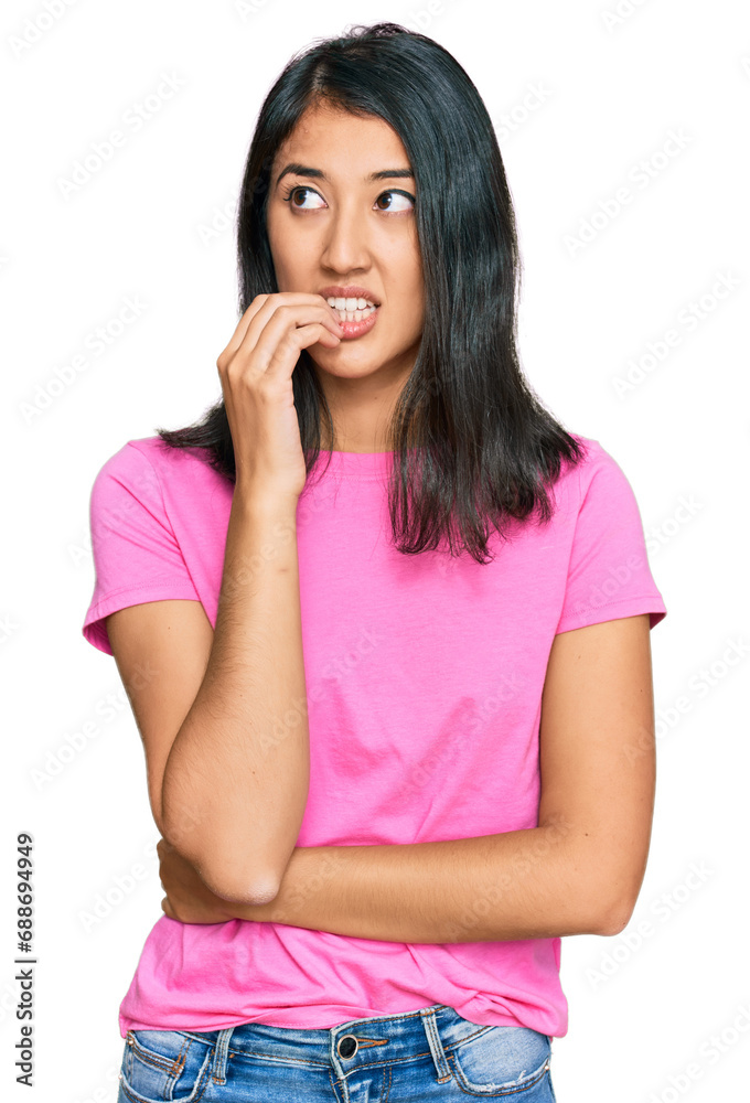 Beautiful asian young woman wearing casual pink t shirt looking stressed and nervous with hands on mouth biting nails. anxiety problem. Beautiful asian young woman wearing casual pink t shirt looking stressed and nervous with hands on mouth biting nails. anxiety problem.