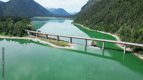 Orbit around Faller-Klamm-Brücke with lake Sylvenstein Reservoir and mountain alps panorama in Bavaria, Germany photo